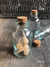 Handmade clay teeth in glass bottle